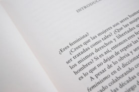 Close-up of hands holding educational materials about gender equality.