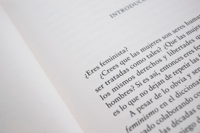 A close-up of an open book page with text in Spanish, discussing feminist topics and gender equality.