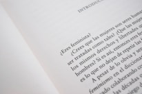 A close-up of an open book page with text in Spanish, discussing feminist topics and gender equality.