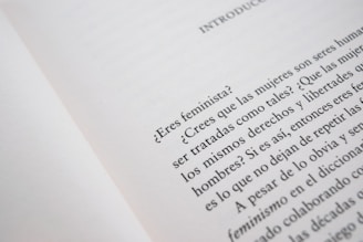 A close-up of an open book page with text in Spanish, discussing feminist topics and gender equality.
