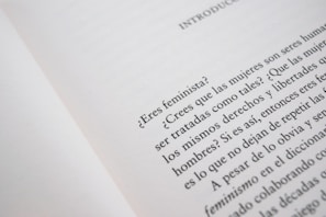 A close-up of an open book page with text in Spanish, discussing feminist topics and gender equality.