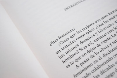 A close-up of an open book page with text in Spanish, discussing feminist topics and gender equality.