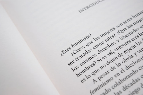 A close-up of an open book page with text in Spanish, discussing feminist topics and gender equality.