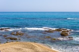 sea waves crashing on shore during daytime
