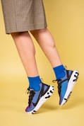 woman in black and white polka dot skirt and black and white nike sneakers