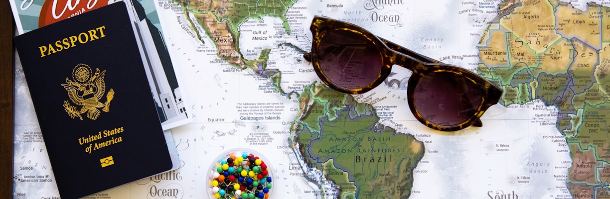 brown framed sunglasses on map