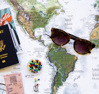 brown framed sunglasses on map