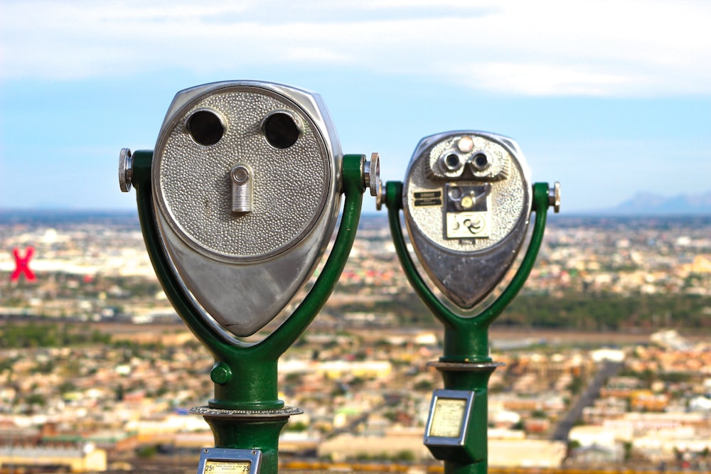 green and gray coin operated binoculars