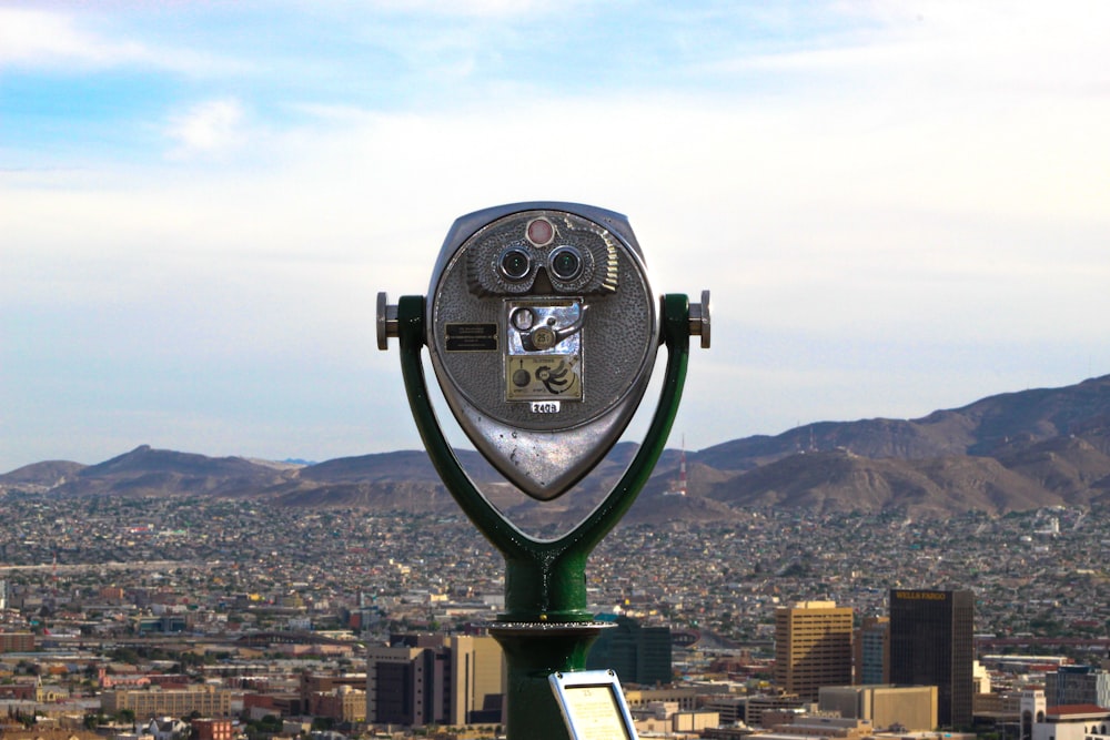 green and black coin operated binoculars