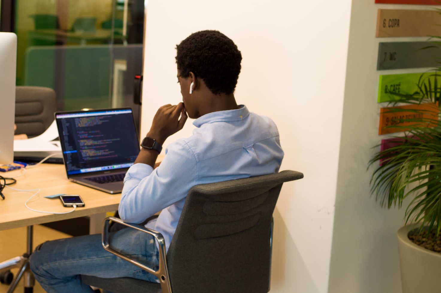 programmer sitting at laptop and coding