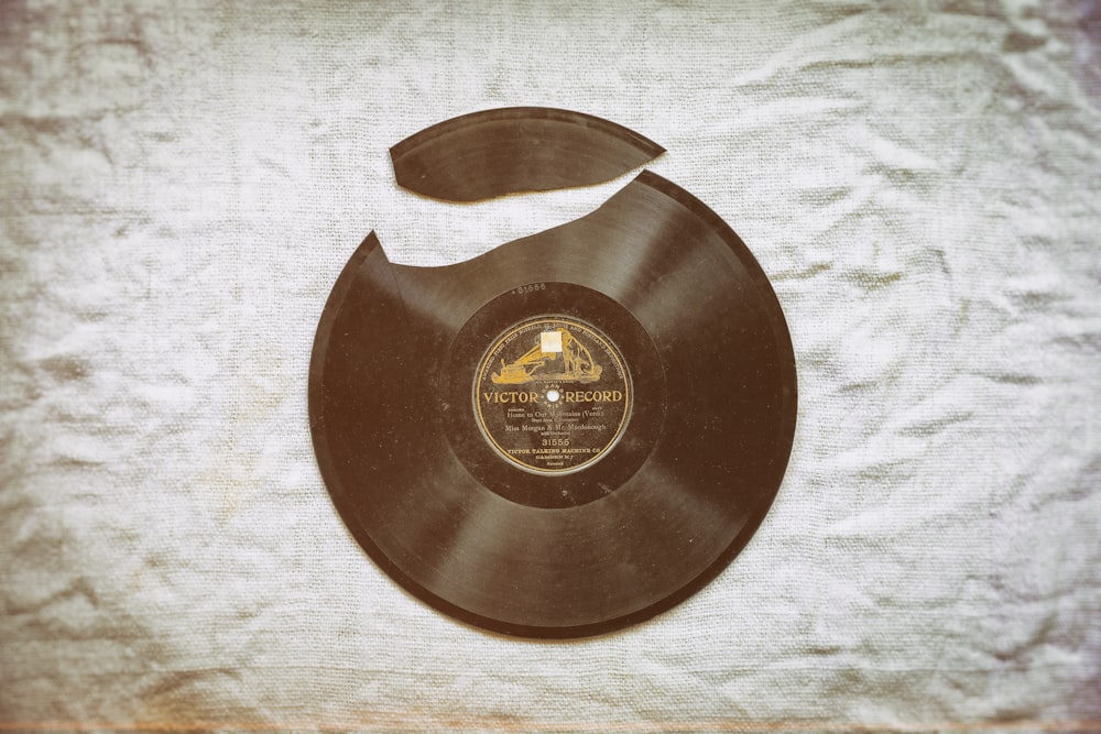brown vinyl record on white textile