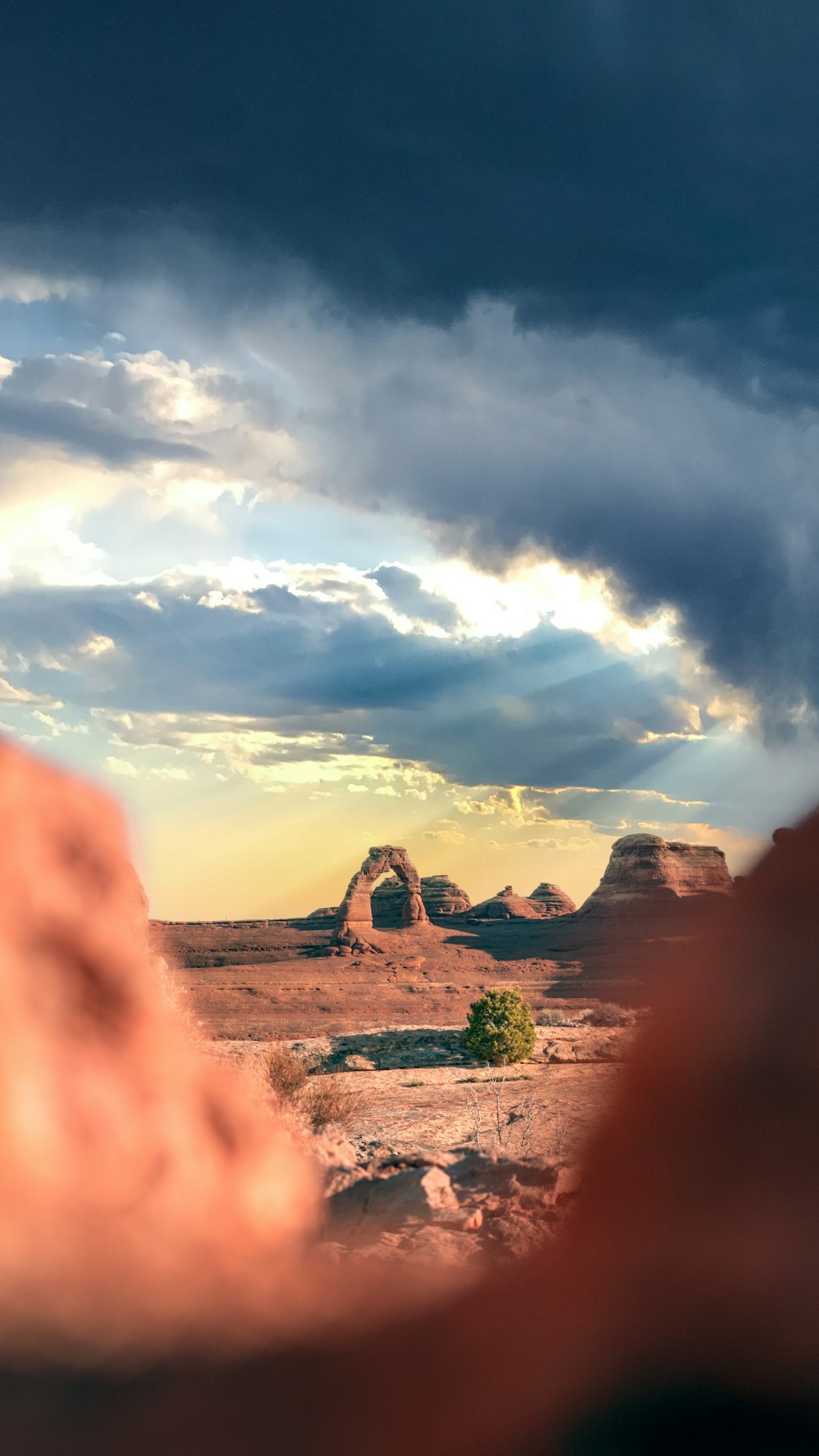 brown rock formation under white clouds during daytime