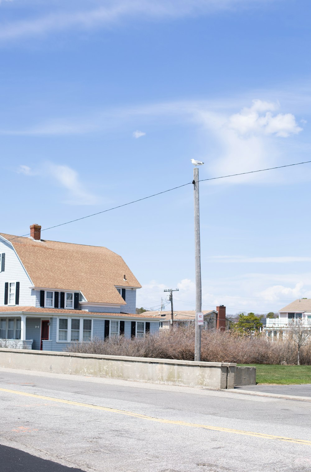 white and brown house near green grass field during daytime