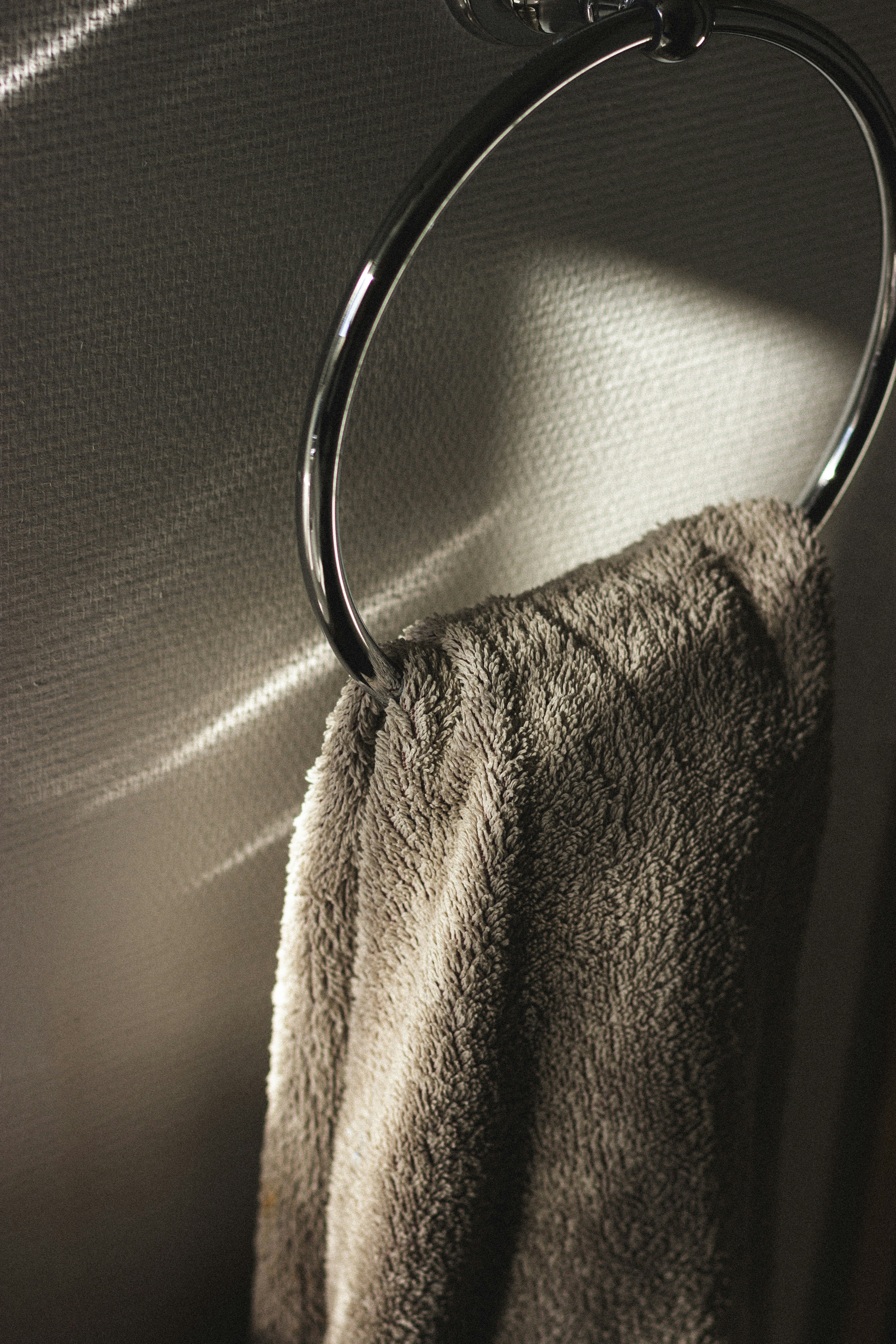 gray towel on stainless steel towel holder