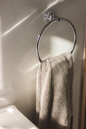 Close-up of glass bathroom accessory like towel holder on tempered glass partition