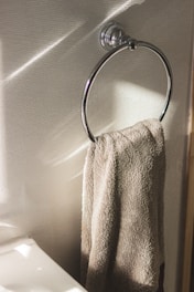 Modern towel hangers installed in a bright, airy bathroom.