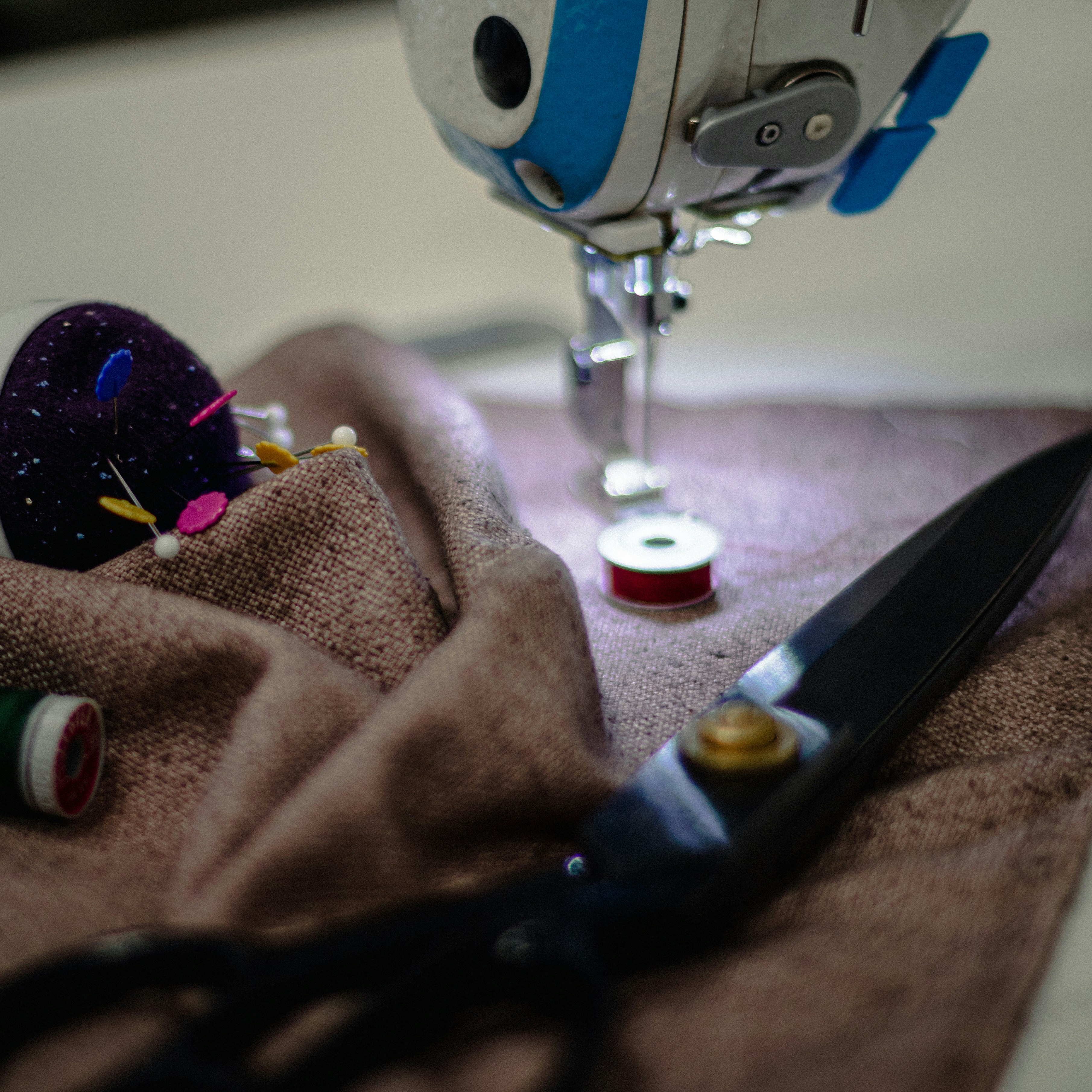 Person in brown pants sitting on a bed