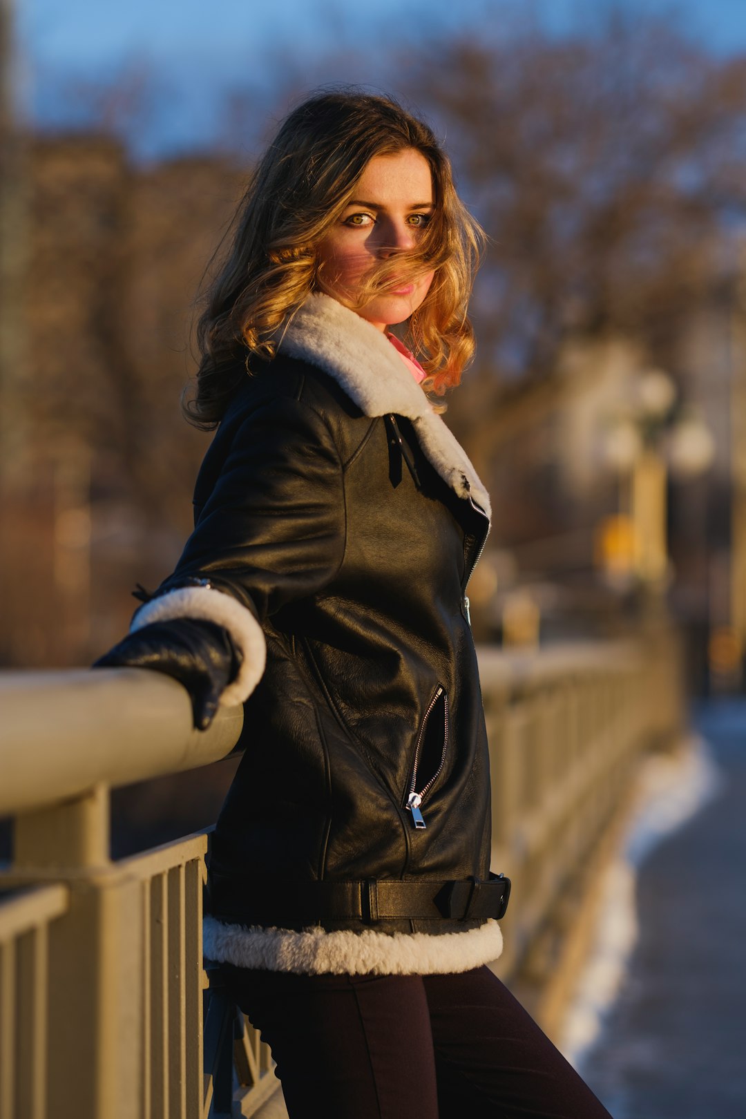 woman in black coat standing on snow covered ground during daytime