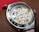 A close-up of a beautifully repaired wristwatch on a workbench.