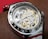 A close-up of a beautifully repaired wristwatch on a workbench.
