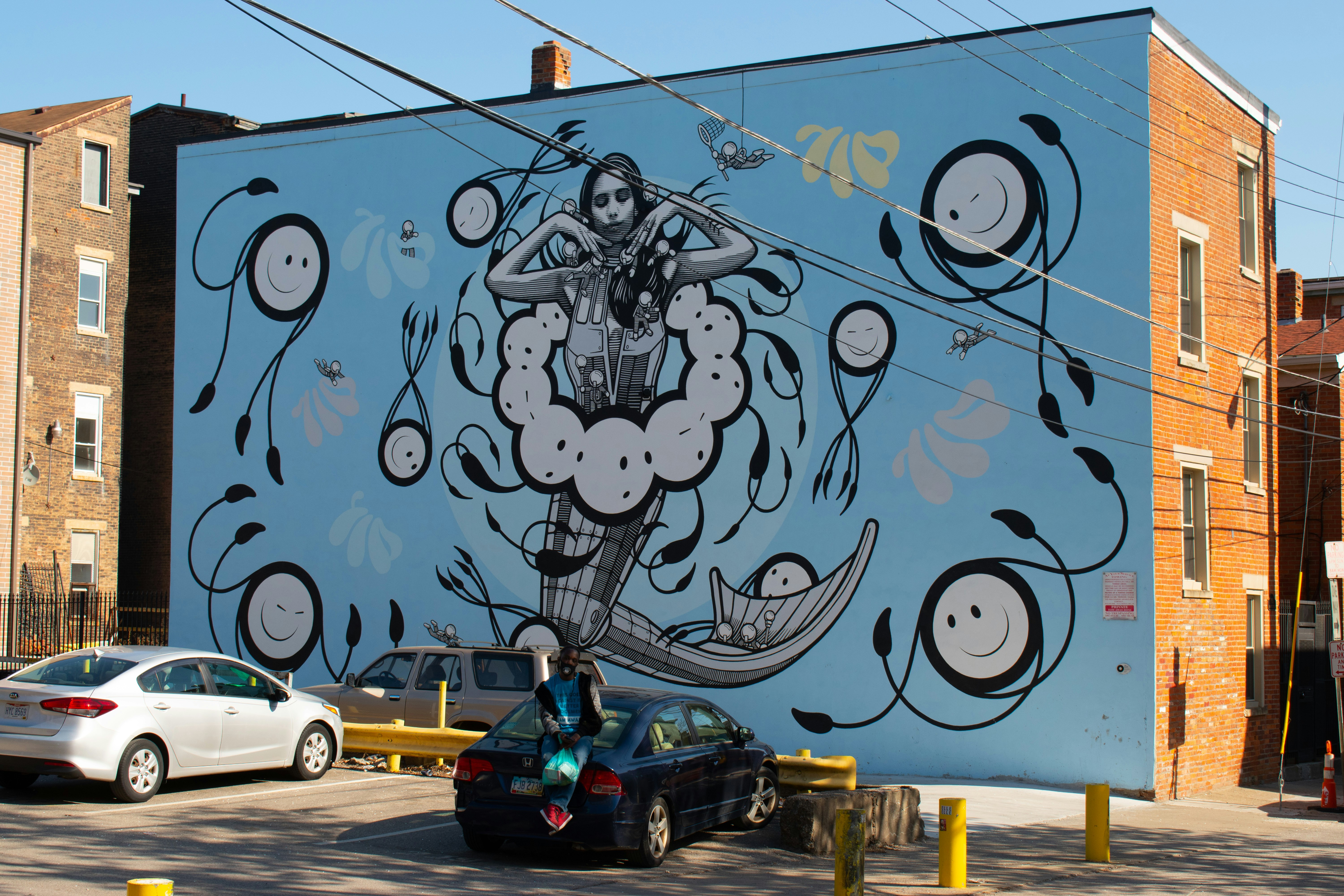 man riding on black and green motorcycle