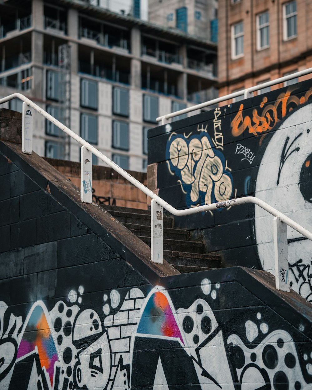 black white and yellow graffiti on black wall