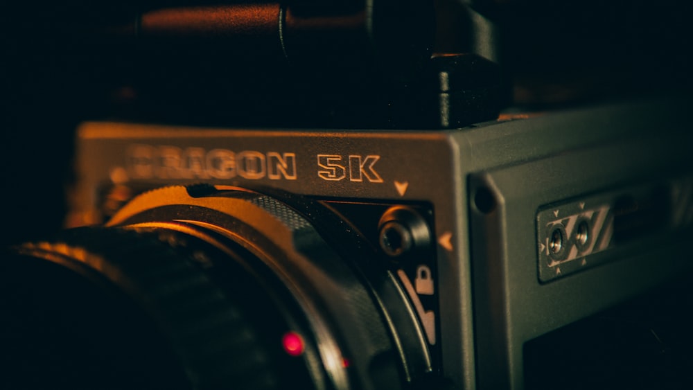 black and silver camera on brown wooden table