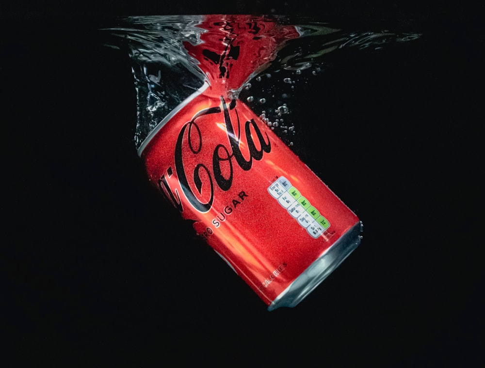 coca cola can on black surface