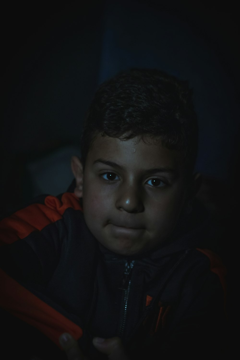 boy in black and red zip up jacket