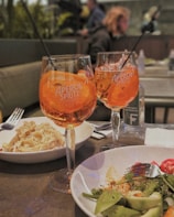 Cozy corporate event scene featuring guests enjoying Italian finger food and Aperol Spritz.