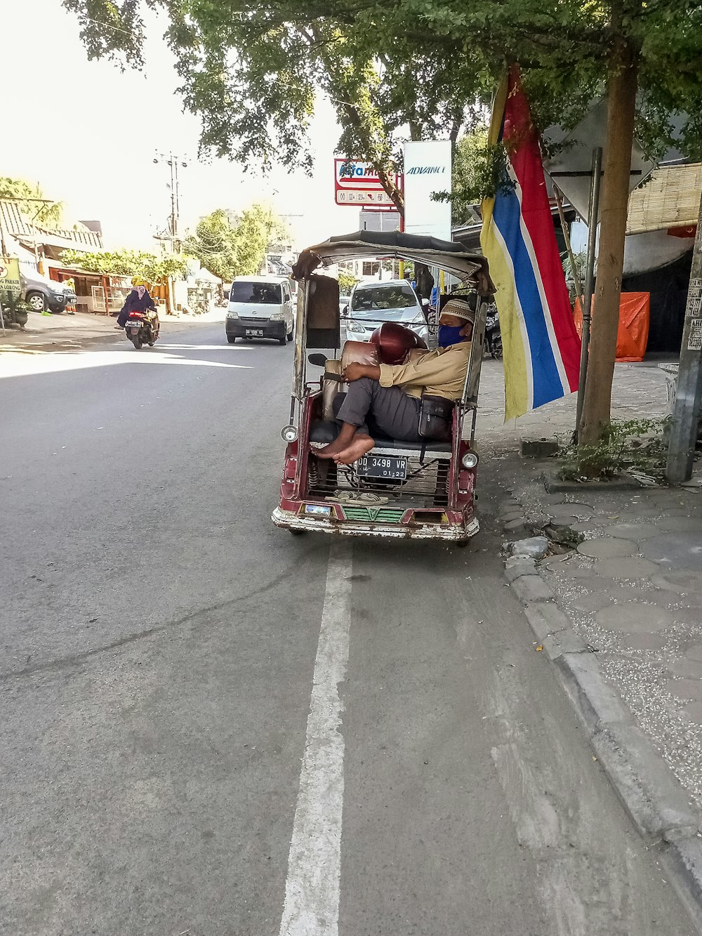 red and blue auto rickshaw on road during daytime