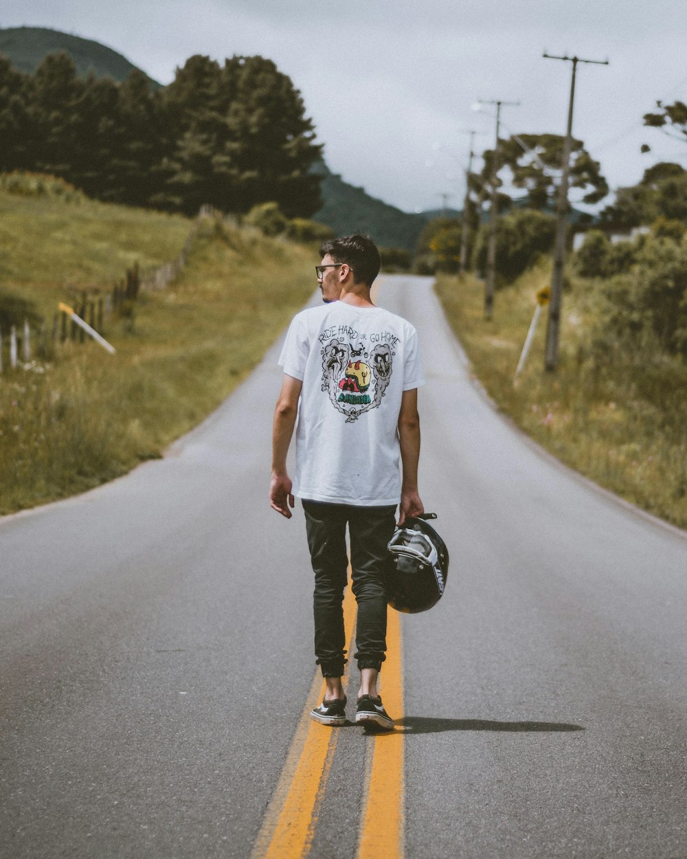 man in white crew neck t-shirt and black shorts running on road during daytime