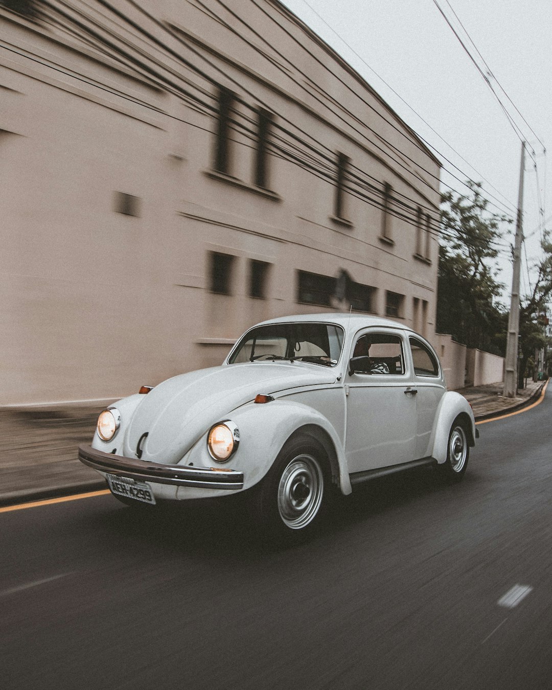 white classic car on road during daytime