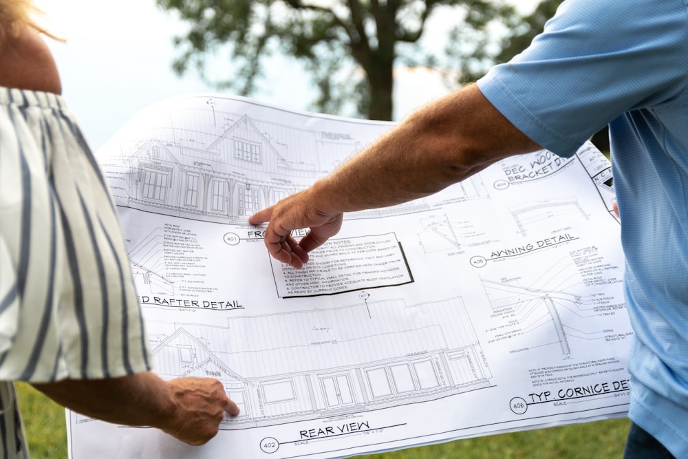 person in blue t-shirt holding white printer paper