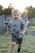 A cheerful child wearing bright pastel-colored shoes, running happily in a sunny park.
