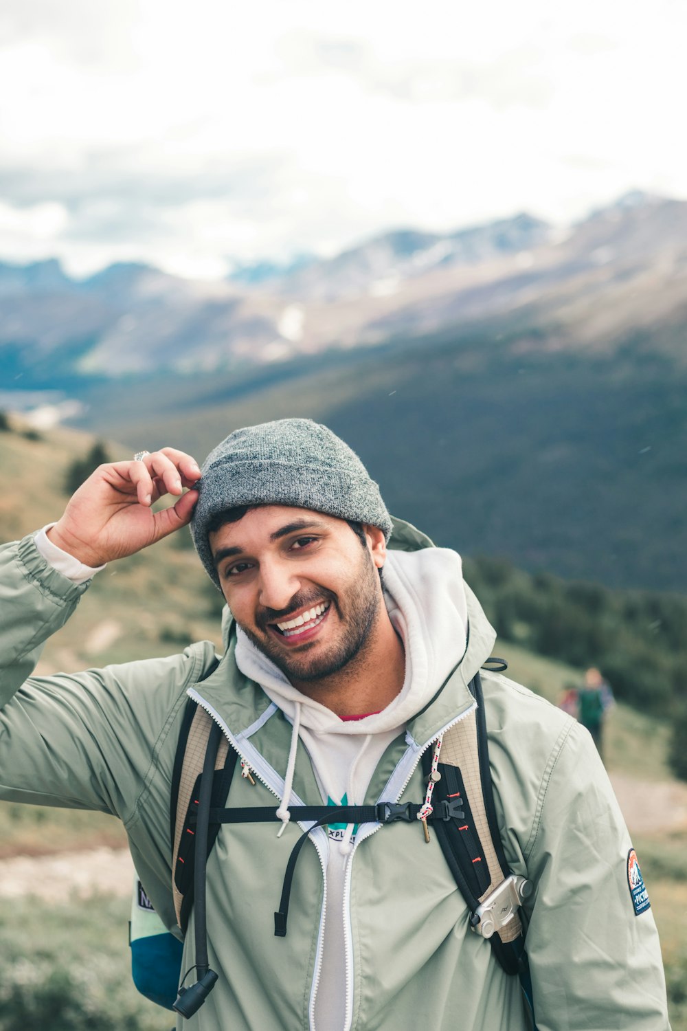 man in gray knit cap and gray zip up jacket