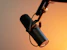 black and silver microphone on brown wall