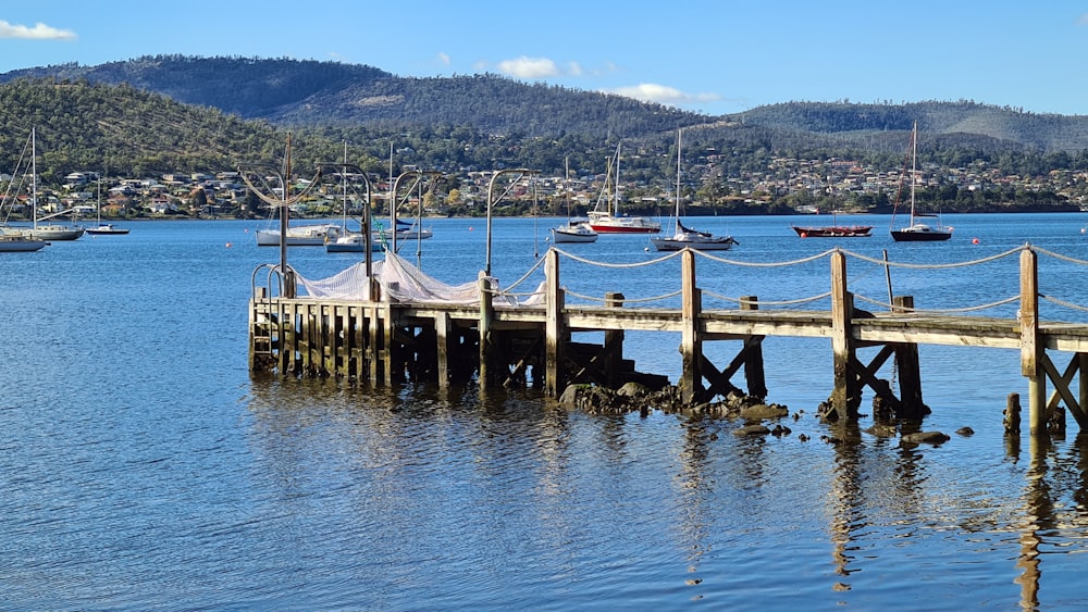 brown wooden dock on blue sea under blue sky during daytime