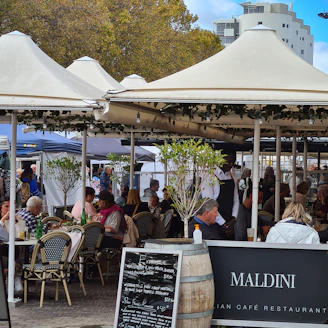 people sitting on chair under white canopy tent during daytime