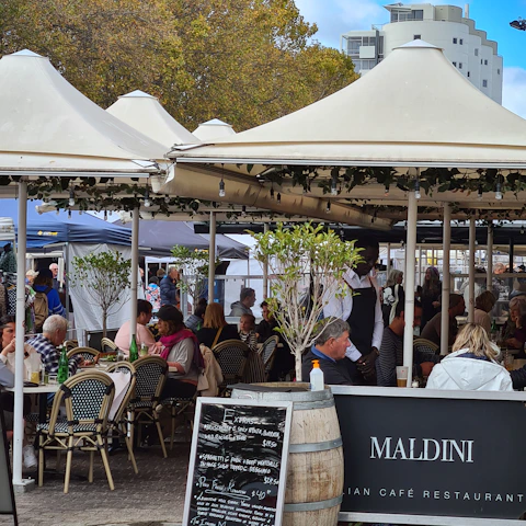 people sitting on chair under white canopy tent during daytime