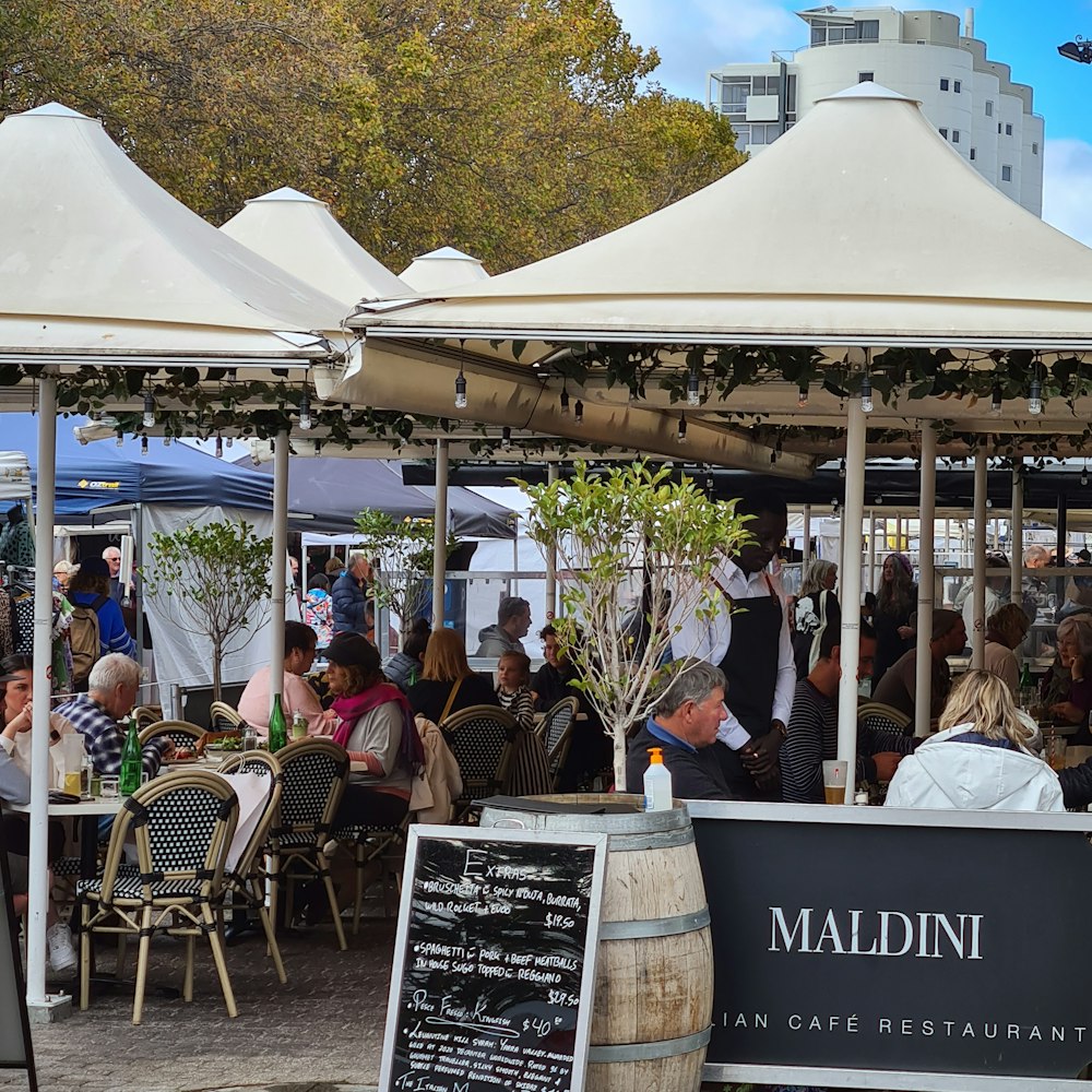 people sitting on chair under white canopy tent during daytime