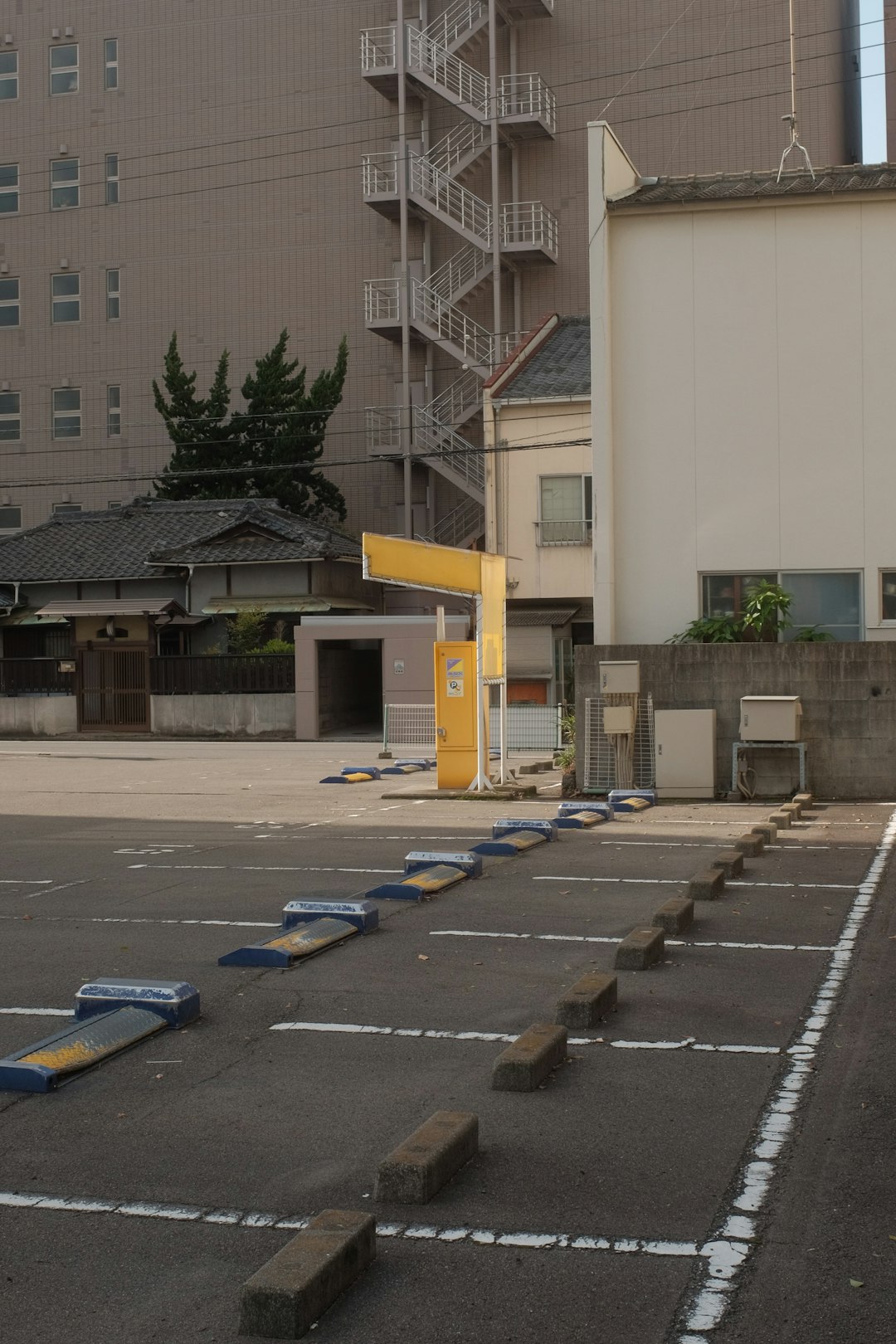 cars parked on parking lot near building during daytime