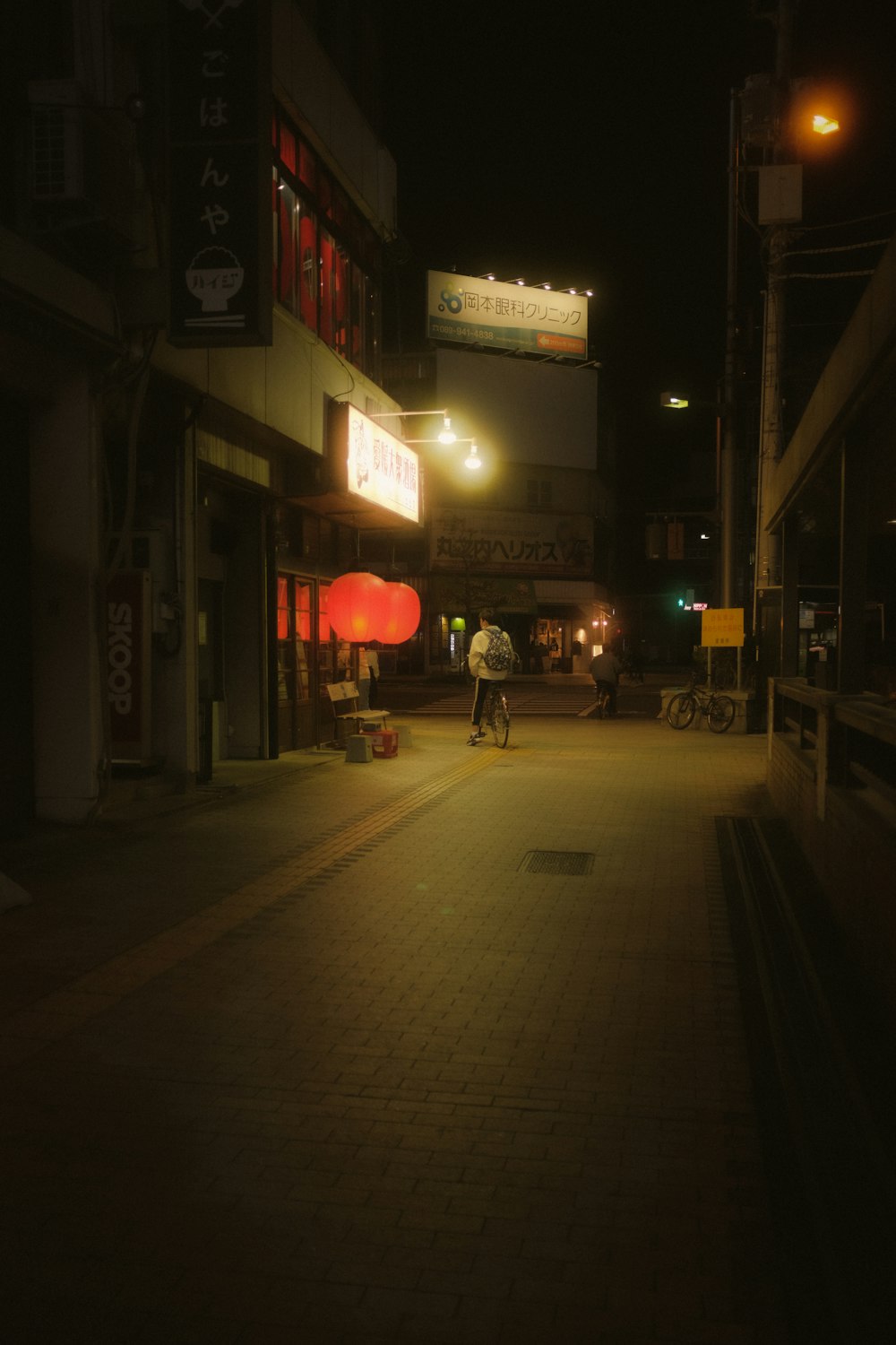 people walking on sidewalk during night time