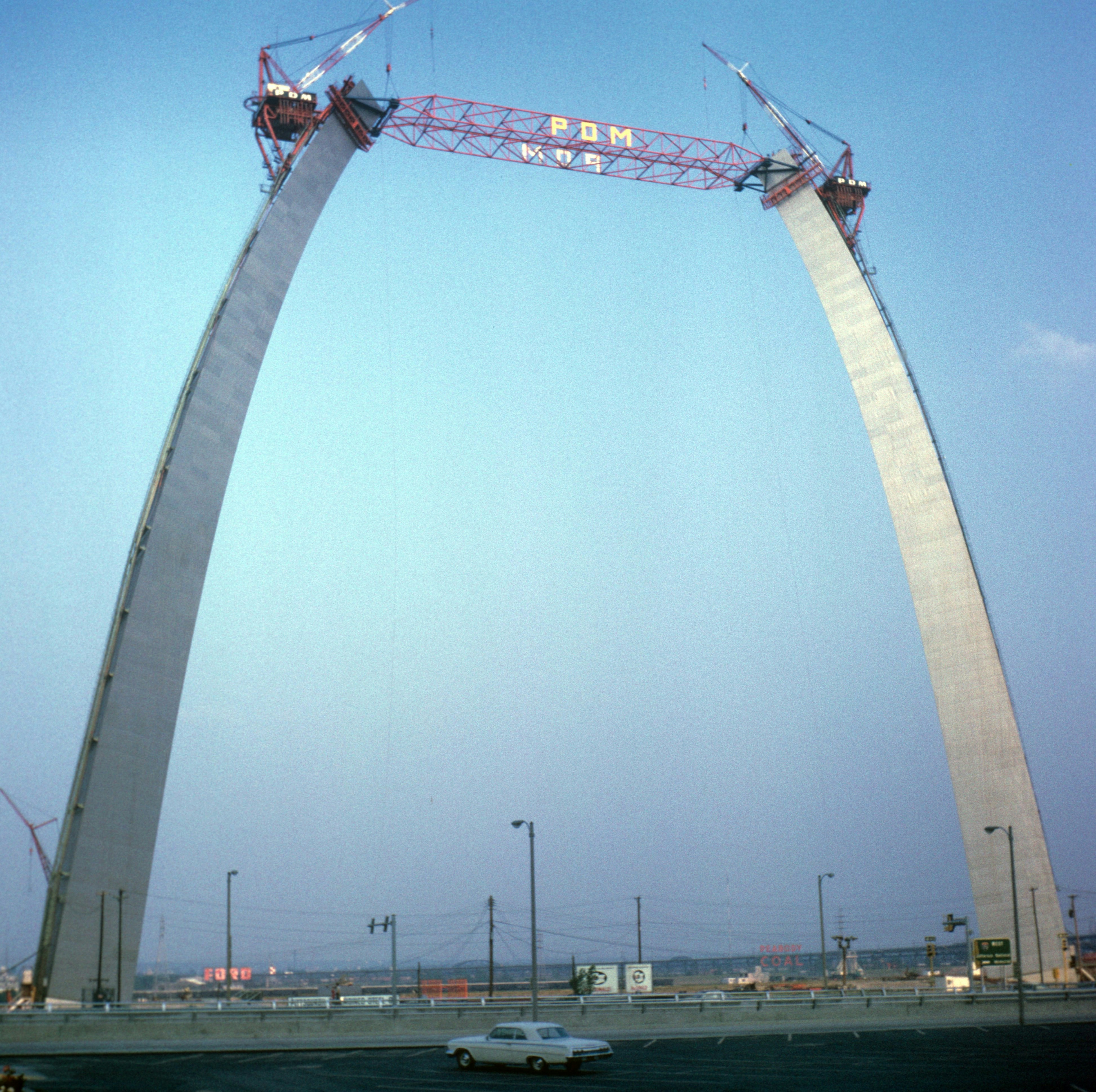 Gateway arch construction with cranes and sky