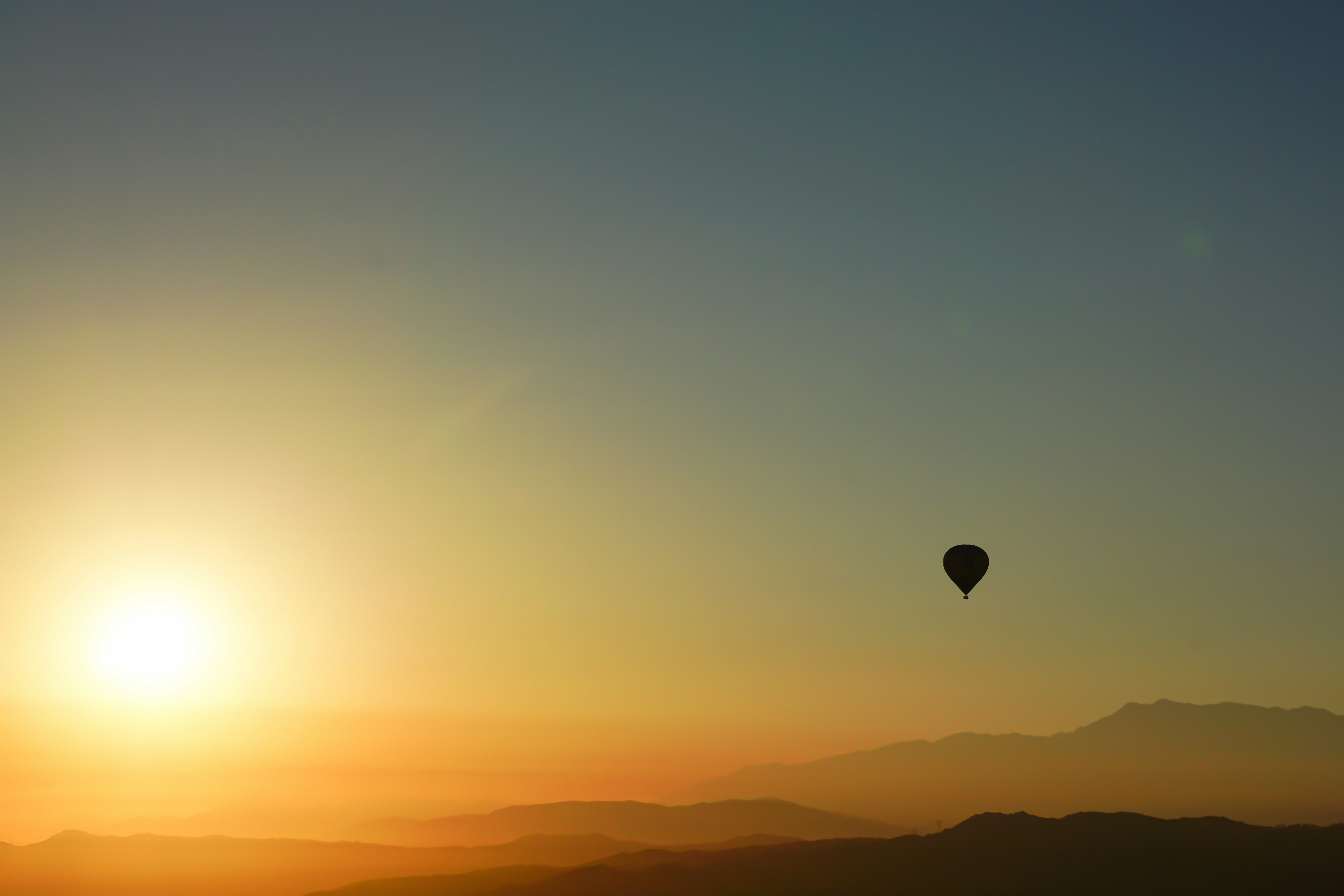silhouette of hot air balloon during sunset