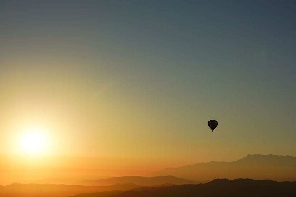 silhouette of hot air balloon during sunset