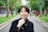 woman in black coat holding cigarette stick
