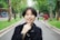 woman in black coat holding cigarette stick