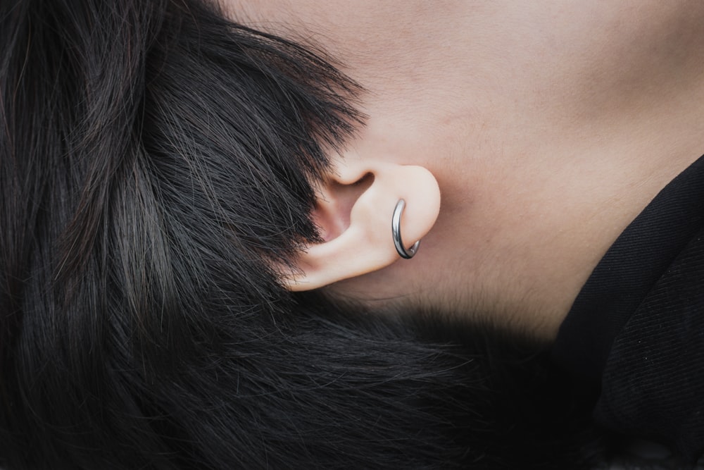woman wearing white earbuds on ear