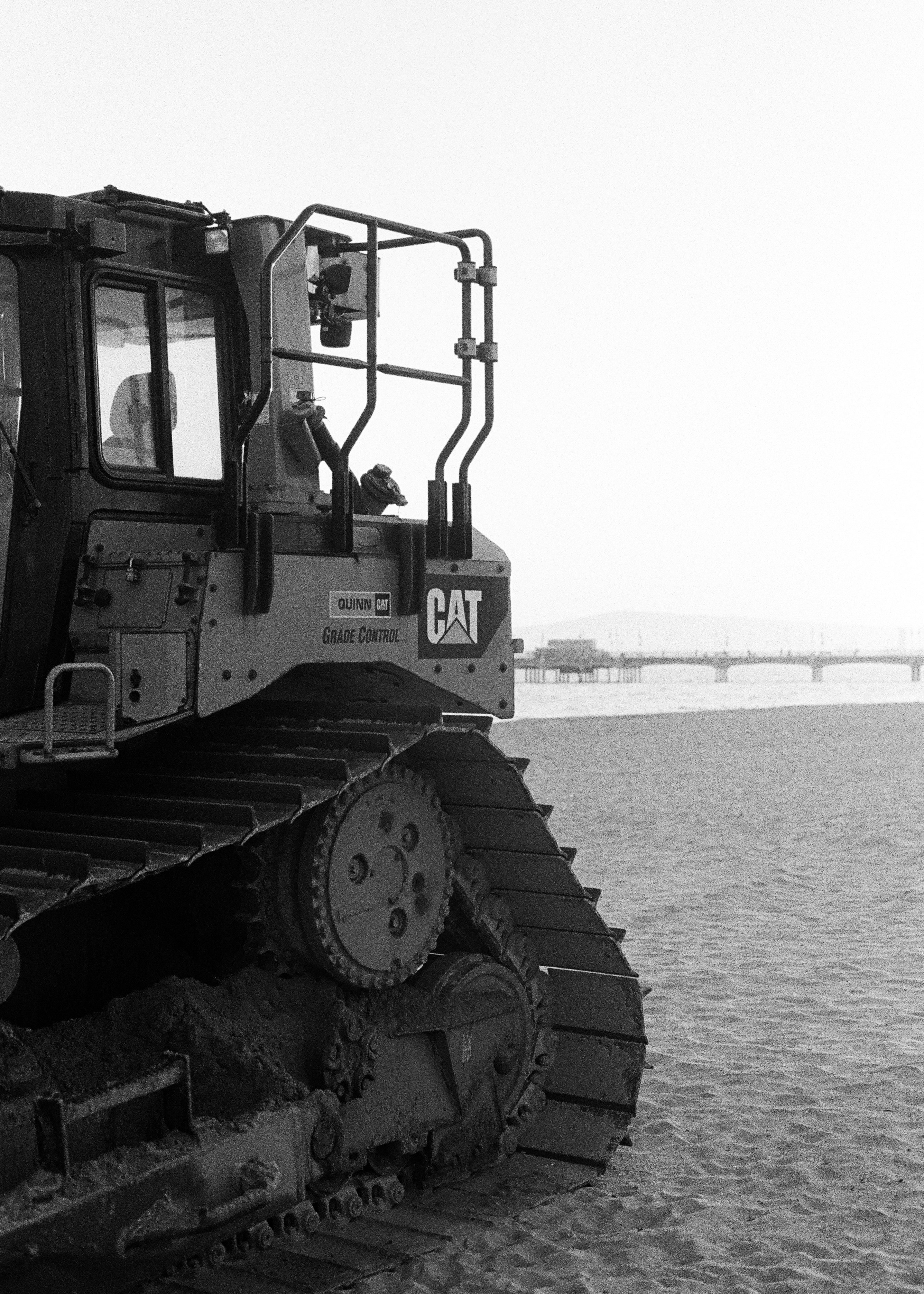 grayscale photo of heavy equipment on water